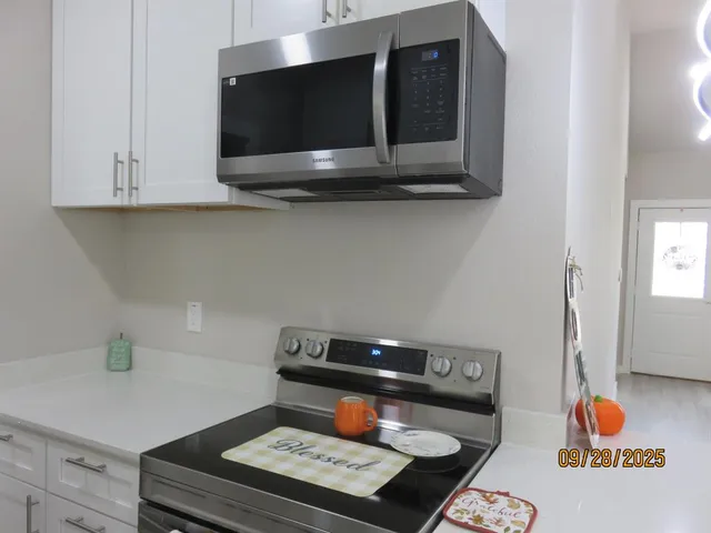 a kitchen with a stove and a microwave