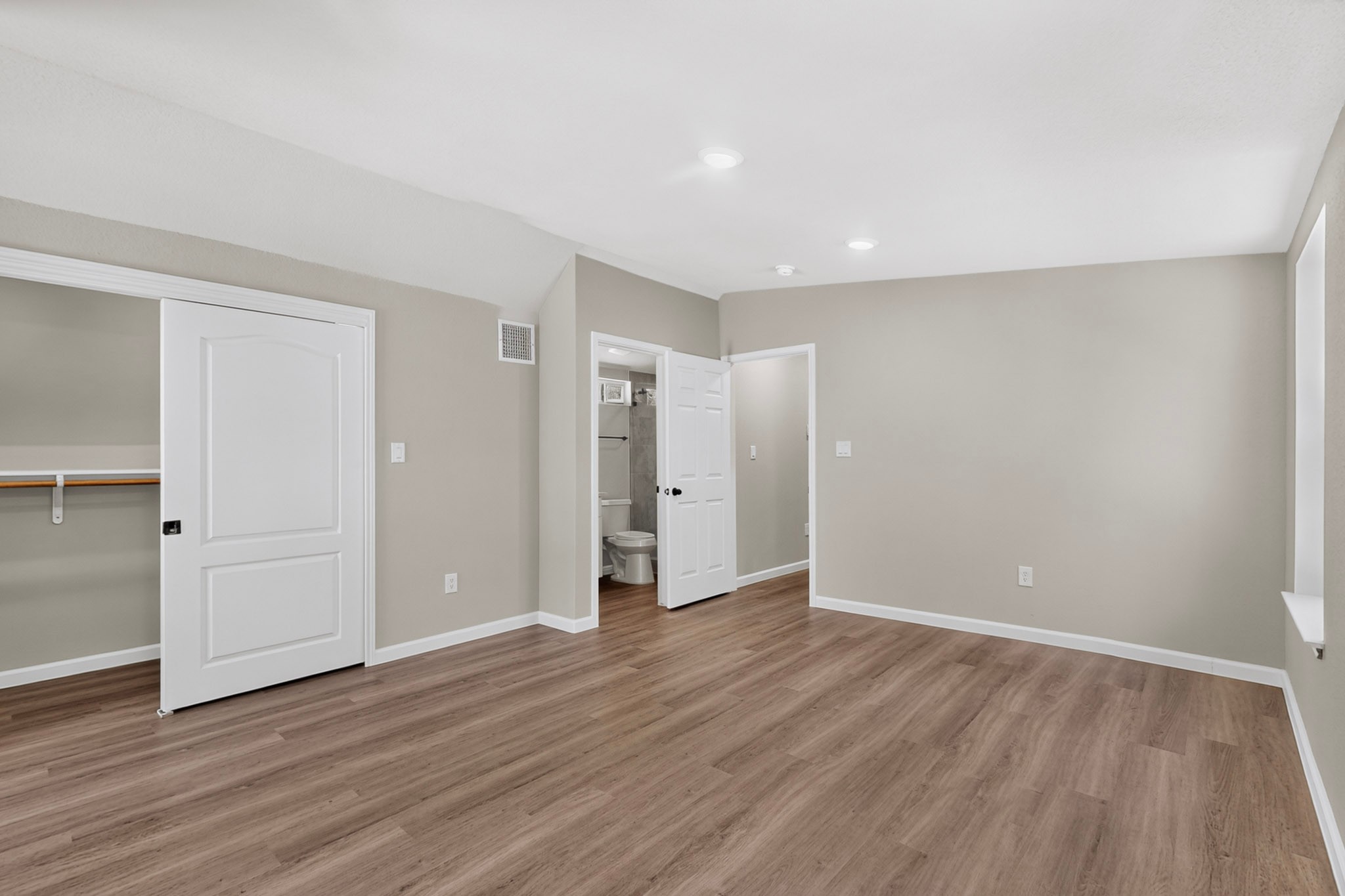 158 Fealy Road Red Rock, TX 78662 - Photo 21 of 40 Gleaming wood-look floors and crisp white trim enhance this versatile upstairs bedroom suite.