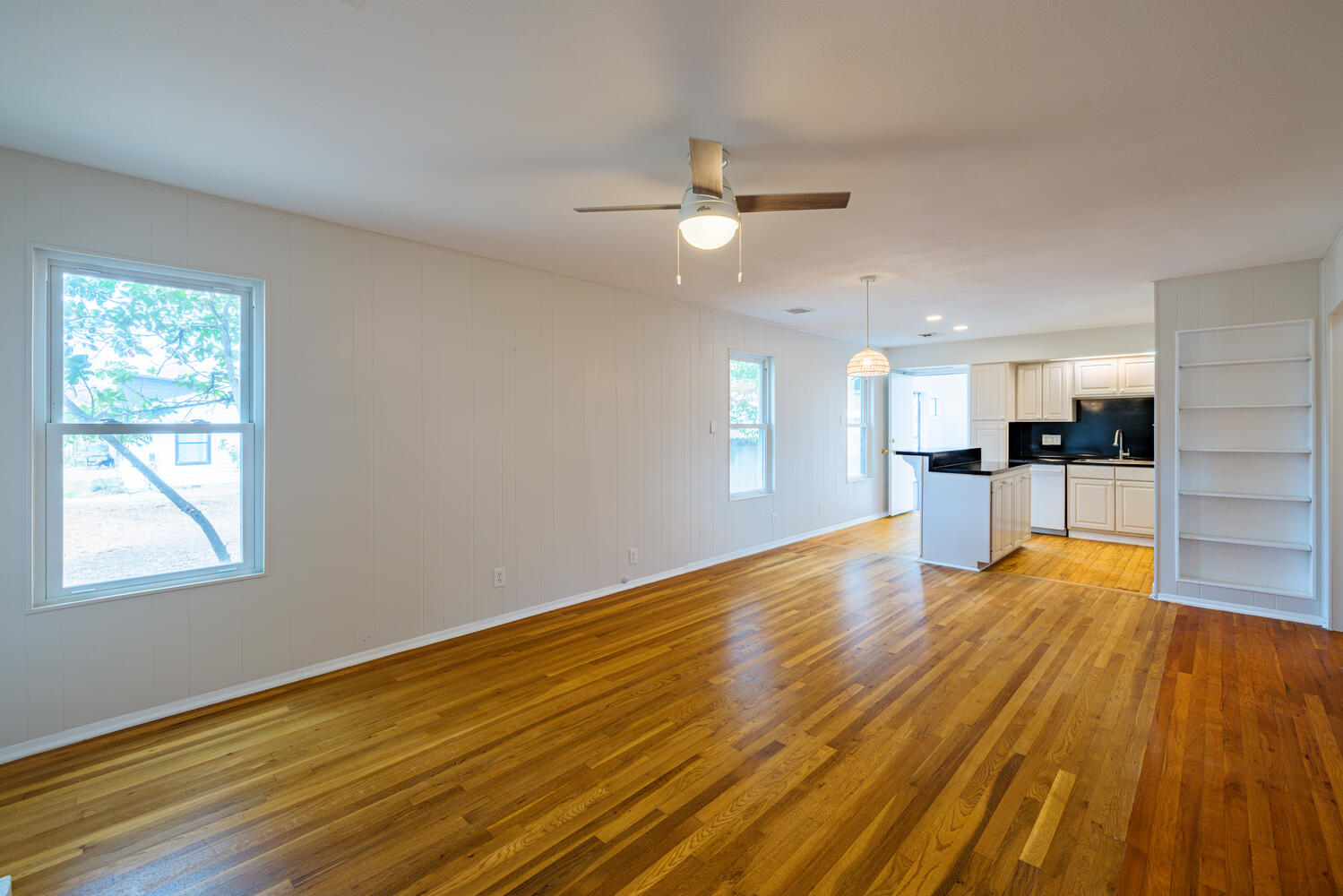 1400 Ruth Avenue Austin, TX 78757 - Photo 6 of 29 Gleaming hardwood floors flow throughout this versatile, open living space leading toward the kitchen.