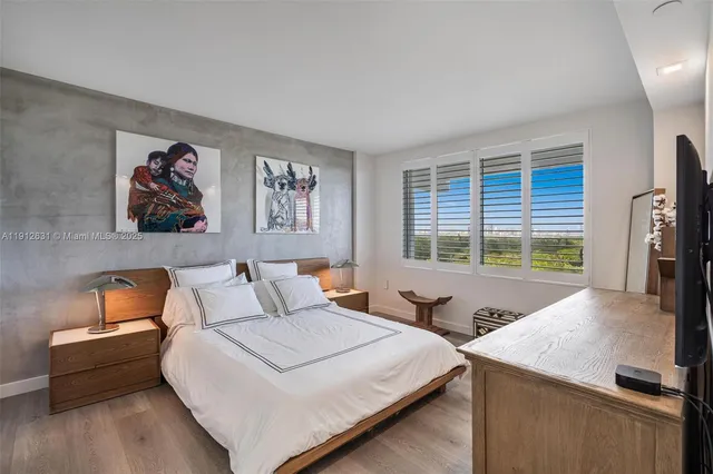 a kitchen with stainless steel appliances a sink stove and wooden floor