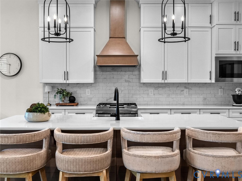 1813 Galley Place Chester, VA 23836 - Photo 16 of 38 Kitchen with a chandelier, white cabinetry, and a