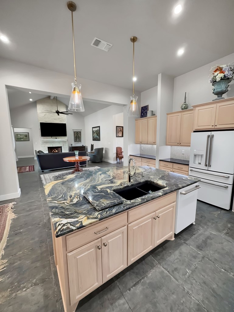 281 Inspiration Loop Comfort, TX 78013 - Photo 11 of 30 a kitchen with stainless steel appliances granite countertop a sink a stove and a wooden floors