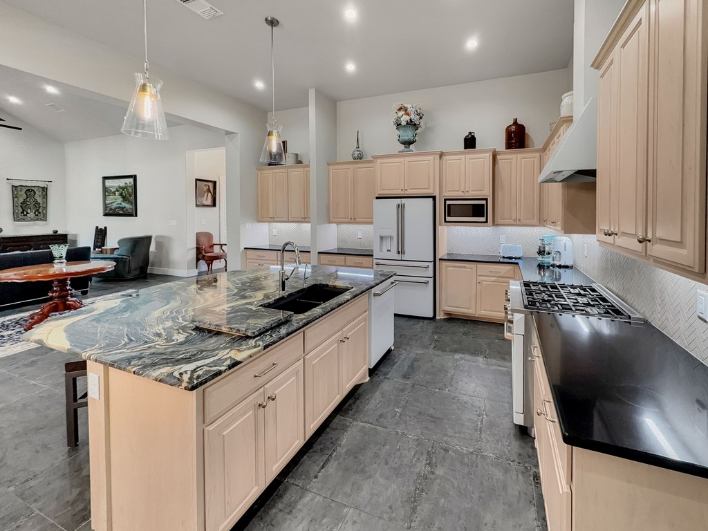 281 Inspiration Loop Comfort, TX 78013 - Photo 12 of 30 a large kitchen with kitchen island a sink appliances and cabinets