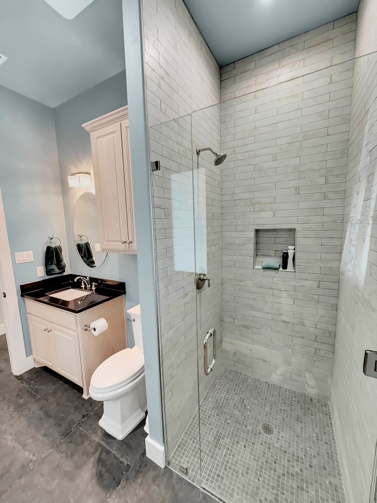 281 Inspiration Loop Comfort, TX 78013 - Photo 16 of 30 a bathroom with a granite countertop sink a toilet a mirror and shower