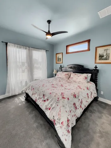 a bedroom with bed and window