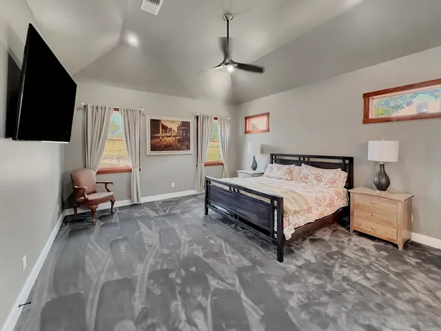 a bedroom with a bed and a flat screen tv