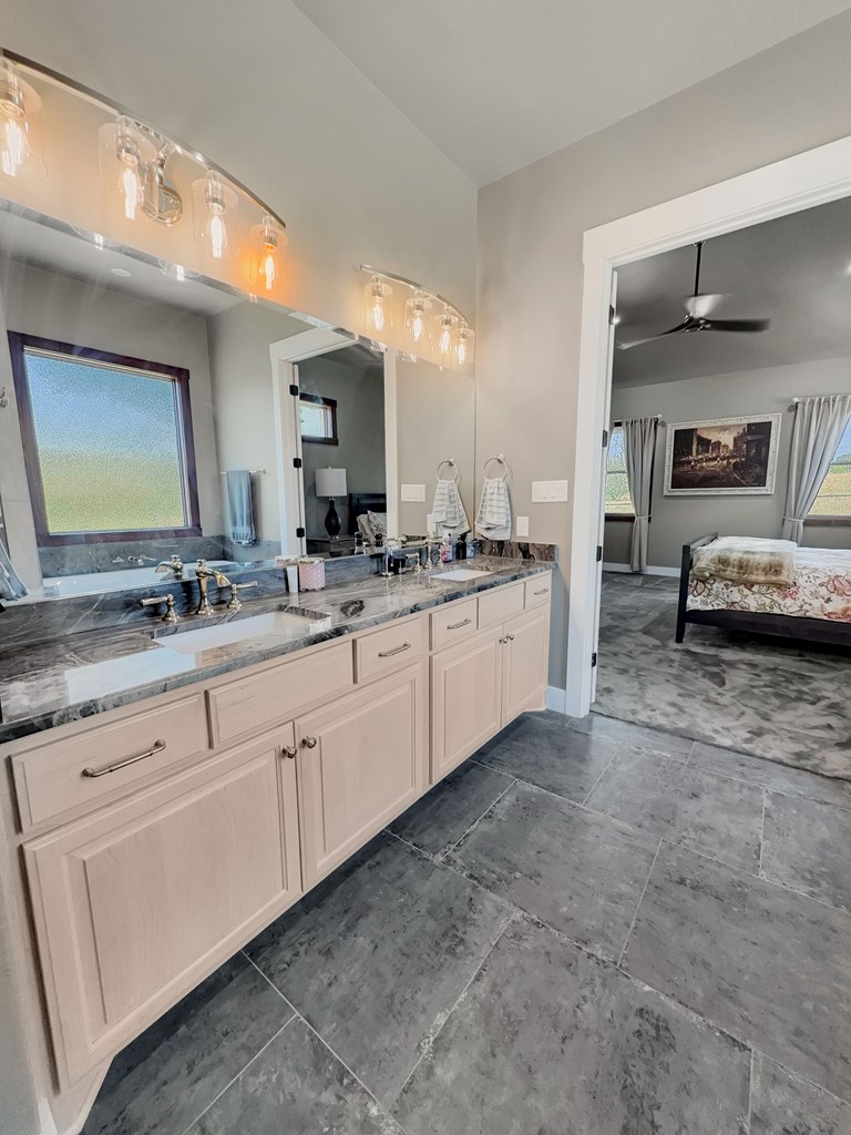 281 Inspiration Loop Comfort, TX 78013 - Photo 24 of 30 a spacious bathroom with a double vanity sink and a mirror