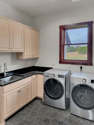 a utility room with sink washer and dryer