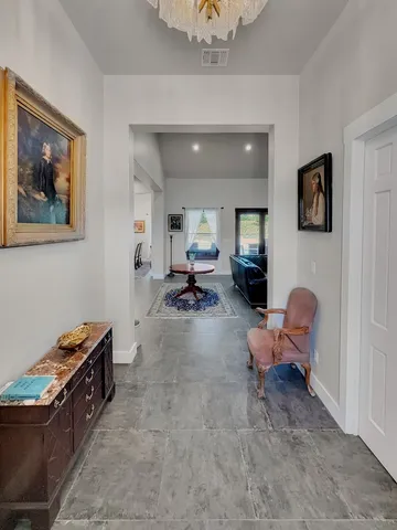 a living room with furniture and a chair