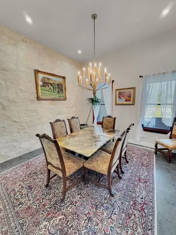 a dining room with a table and chairs