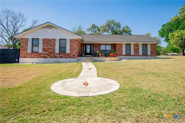 a front view of a house with swimming pool having outdoor seating