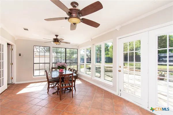 a view of a dining room with furniture and window