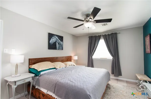a bedroom with a large bed and a chandelier