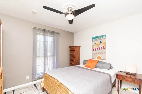 a bedroom with a bed and cabinets