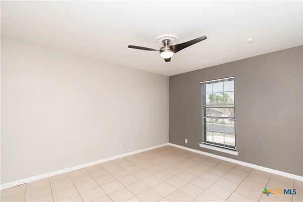 an empty room with a ceiling fan