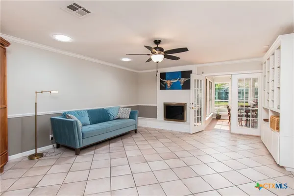 a view of a livingroom with an empty space and a fireplace