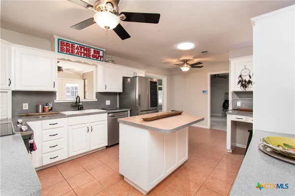a kitchen with stainless steel appliances cabinets a sink and a stove