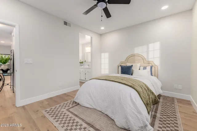 a bedroom with a bed and wooden floor