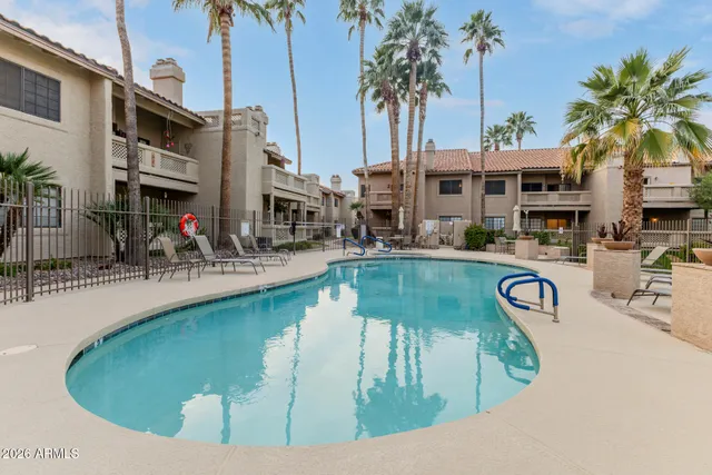 a view of a swimming pool with outdoor seating