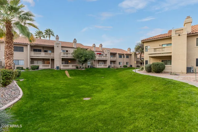 a view of a house with a big yard and large trees