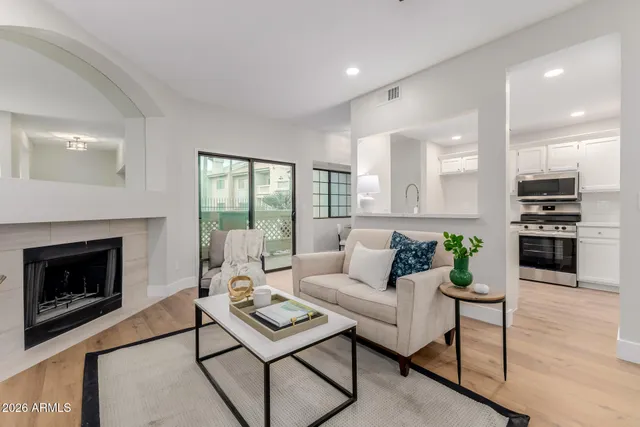 a living room with furniture a fireplace and a flat screen tv