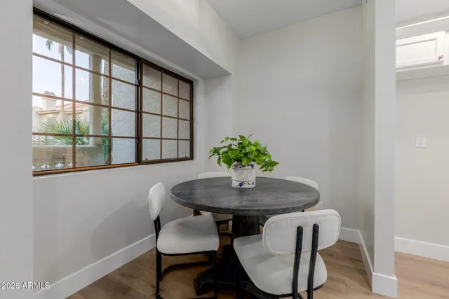 a dining room with furniture and window