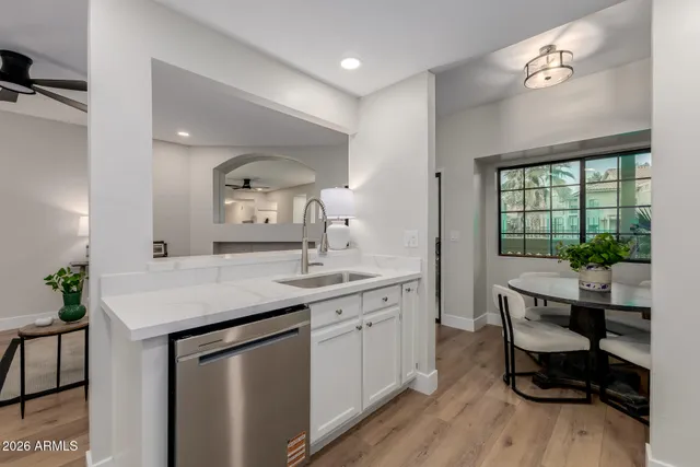 a kitchen with a sink cabinets and wooden floor