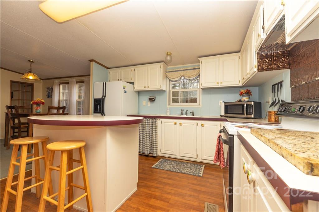 401 Azalea Circle Marshall, NC 28753 - Photo 5 of 11 a kitchen with stainless steel appliances granite countertop a stove a sink and a refrigerator