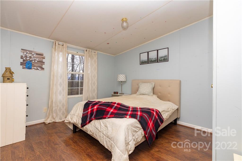 401 Azalea Circle Marshall, NC 28753 - Photo 7 of 11 a bedroom with a bed and a window