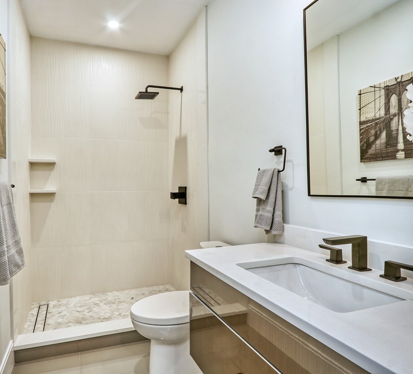 75 Greenough Street, Unit 1 Brookline, MA 02445 - Photo 17 of 22 a bathroom with a granite countertop sink toilet and shower