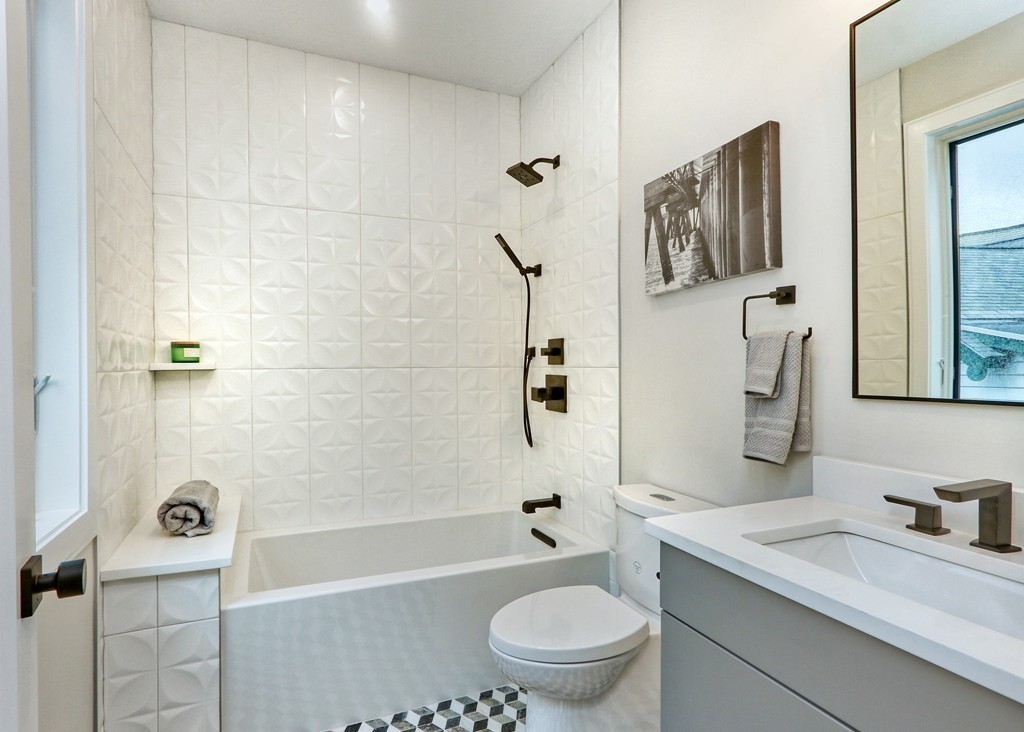 75 Greenough Street, Unit 1 Brookline, MA 02445 - Photo 19 of 22 a bathroom with a granite countertop toilet sink and mirror