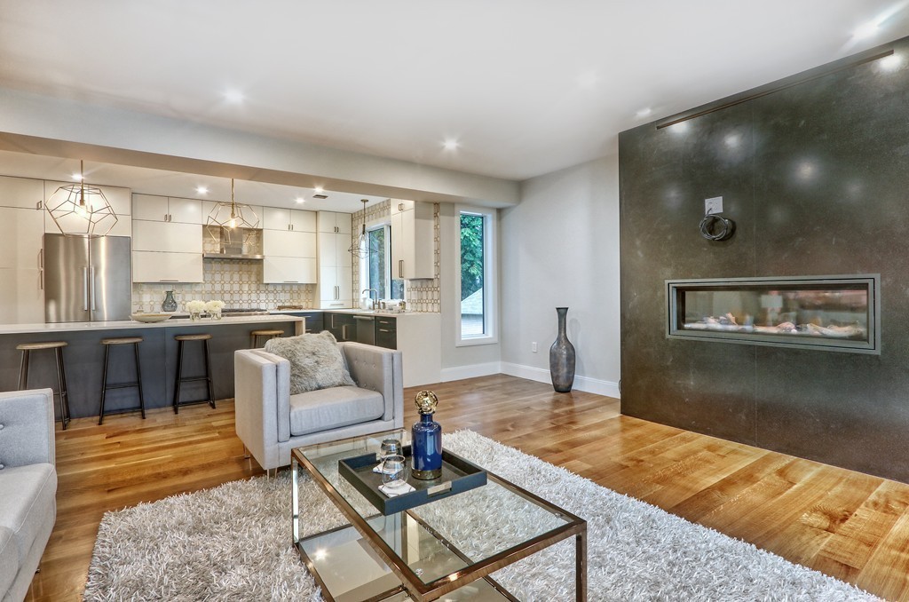 75 Greenough Street, Unit 1 Brookline, MA 02445 - Photo 6 of 22 a living room with kitchen island furniture and a kitchen view