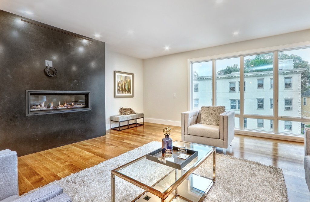 75 Greenough Street, Unit 1 Brookline, MA 02445 - Photo 8 of 22 a living room with furniture and a table