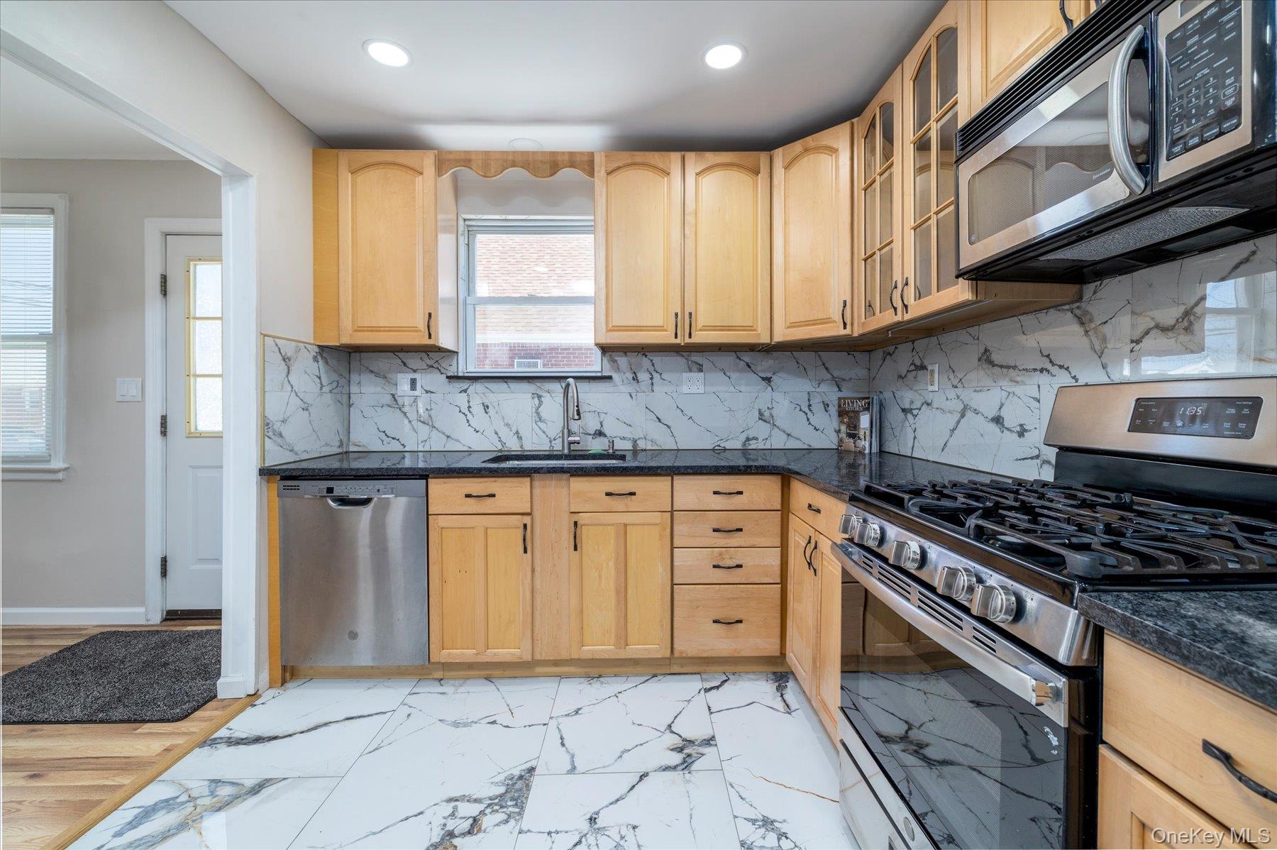 191 Raff Avenue Mineola, NY 11501 - Photo 14 of 25 a kitchen with granite countertop cabinets stainless steel appliances a sink and a counter top space