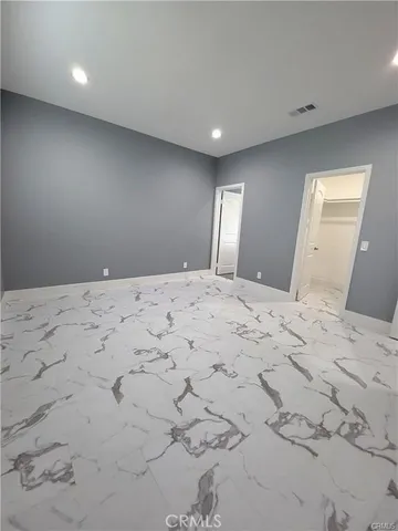 a large bedroom with a bed