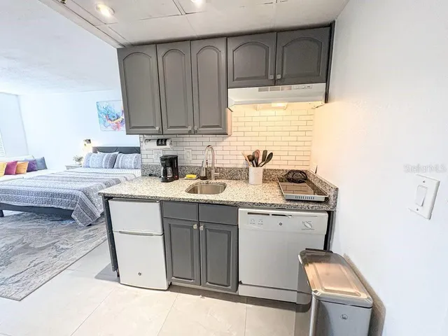 a kitchen with a sink cabinets and window