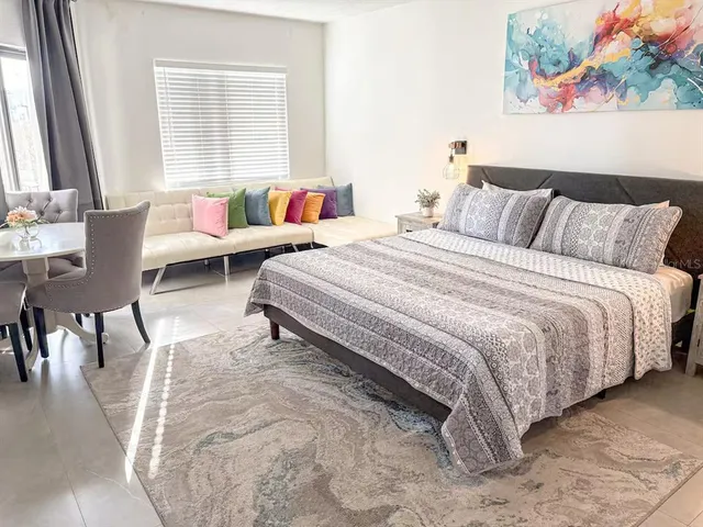 a spacious bedroom with a bed and a couch