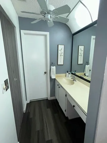 a bathroom with a sink a mirror and a shower