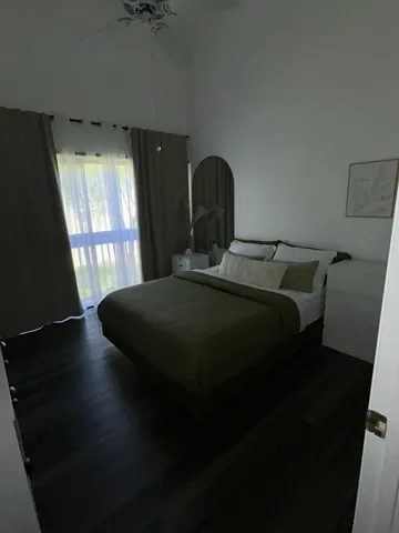 a bed sitting in a bedroom next to a window