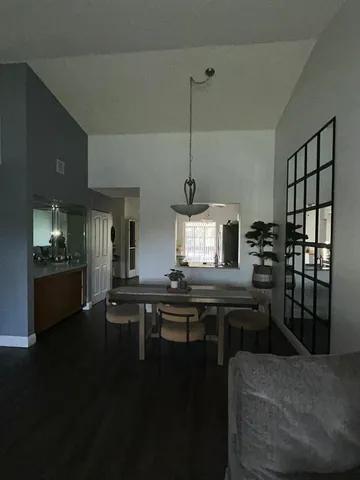 a kitchen with a table chairs stove and cabinets