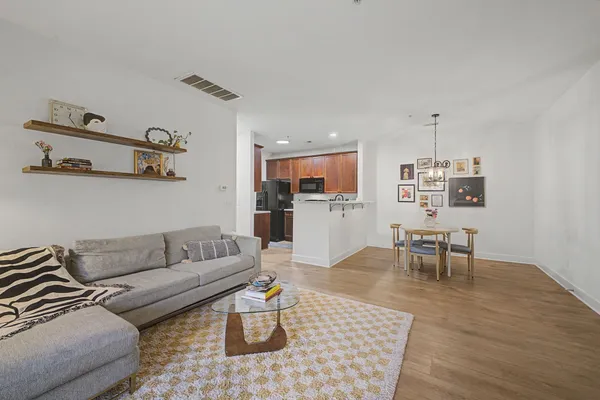a living room with furniture and view of kitchen