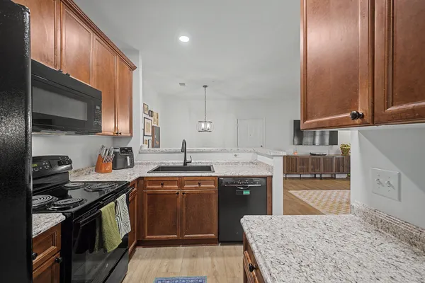 a kitchen with stainless steel appliances granite countertop a sink stove and cabinets
