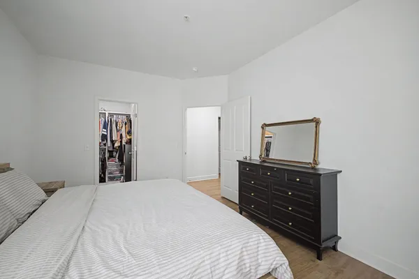 a bedroom with a bed and a dresser
