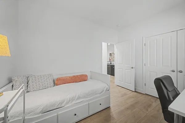 a bedroom with a bed and chair