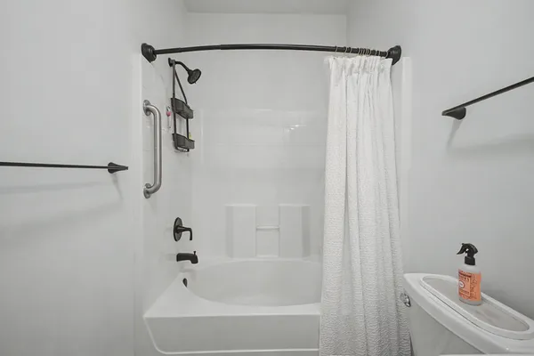 a bathroom with a bathtub and a shower