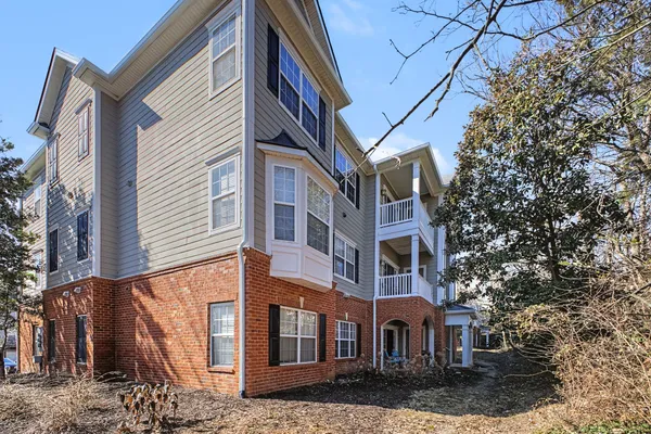 a front view of a residential apartment building with a yard