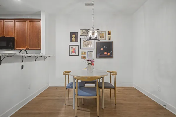 a view of a dining room with furniture wooden floor and a chandelier