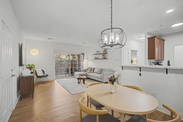 a spacious bathroom with a table chairs and a chandelier