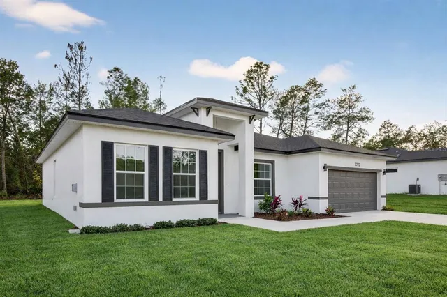 a view of a house with a backyard