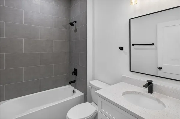 a bathroom with a sink toilet bathtub and vanity